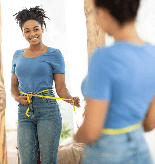 happy-black-girl-after-weight-loss-measuring-waist